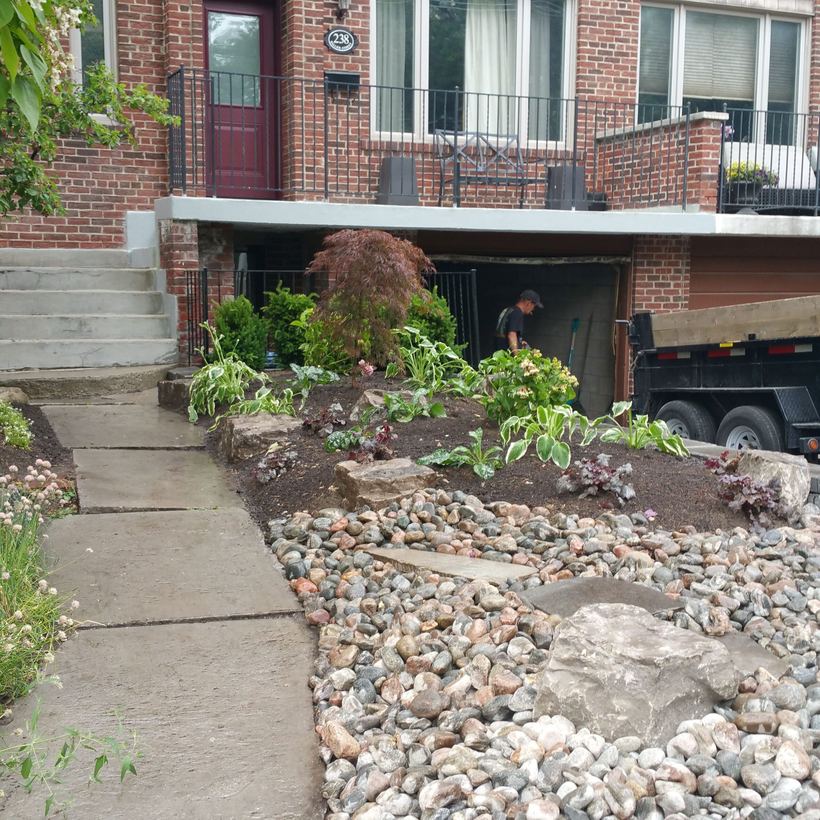 Front yard landscaping with river rock