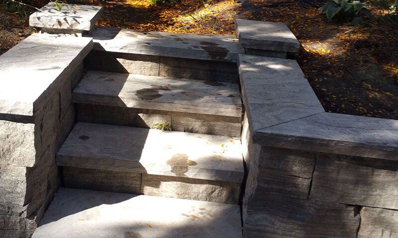 Bush-hammered Eramosa stairs set between two capped stone walls