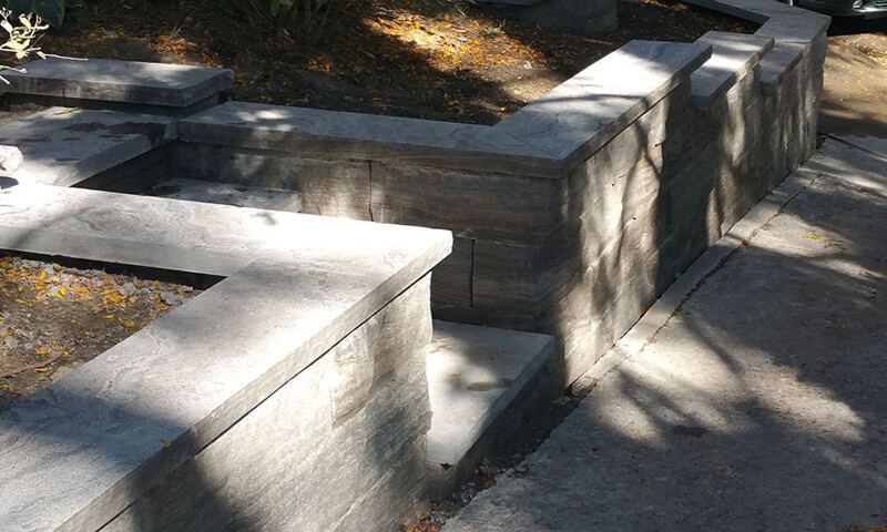 Stepped natural stone planter walls with Eramosa coping