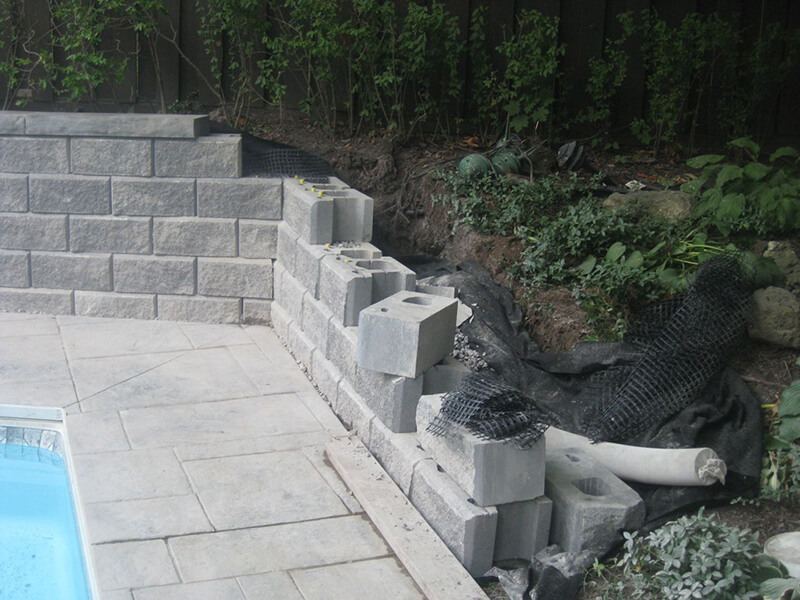 Precast wall under construction by a pool