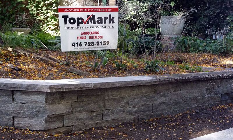 Top Mark job-site sign on a completed wall